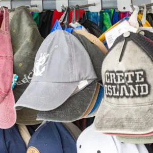 Assorted caps hanging on a display rack.